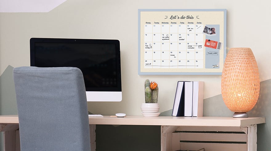 Home office with a weekly planner board on the wall